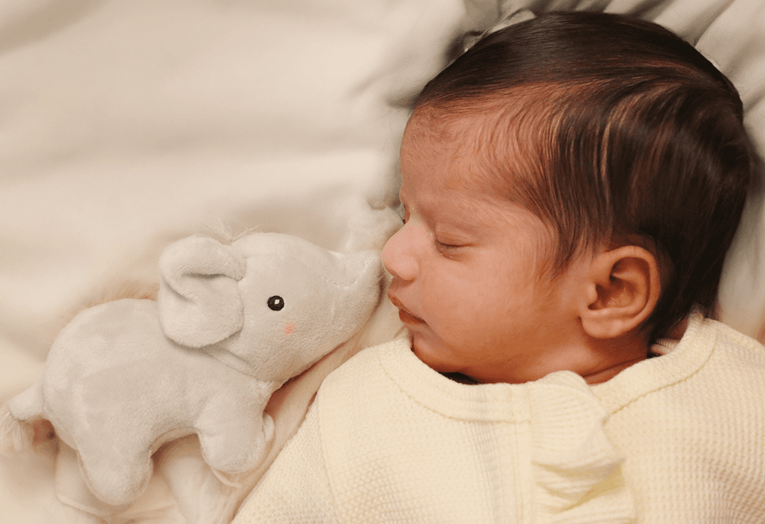 Beautiful stylish blonde woman in trench coat looking away dreamily